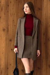 a lady in a red sweater and a brown suit